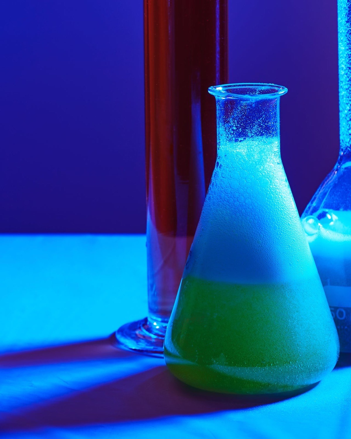 Laboratory flasks of blue and green liquid